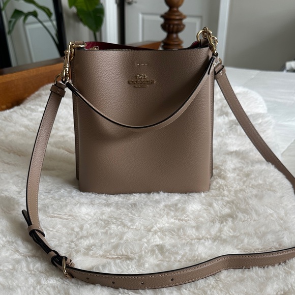 Coach Handbags - Coach Taupe Leather Crossbody Bucket Bag with Red Interior